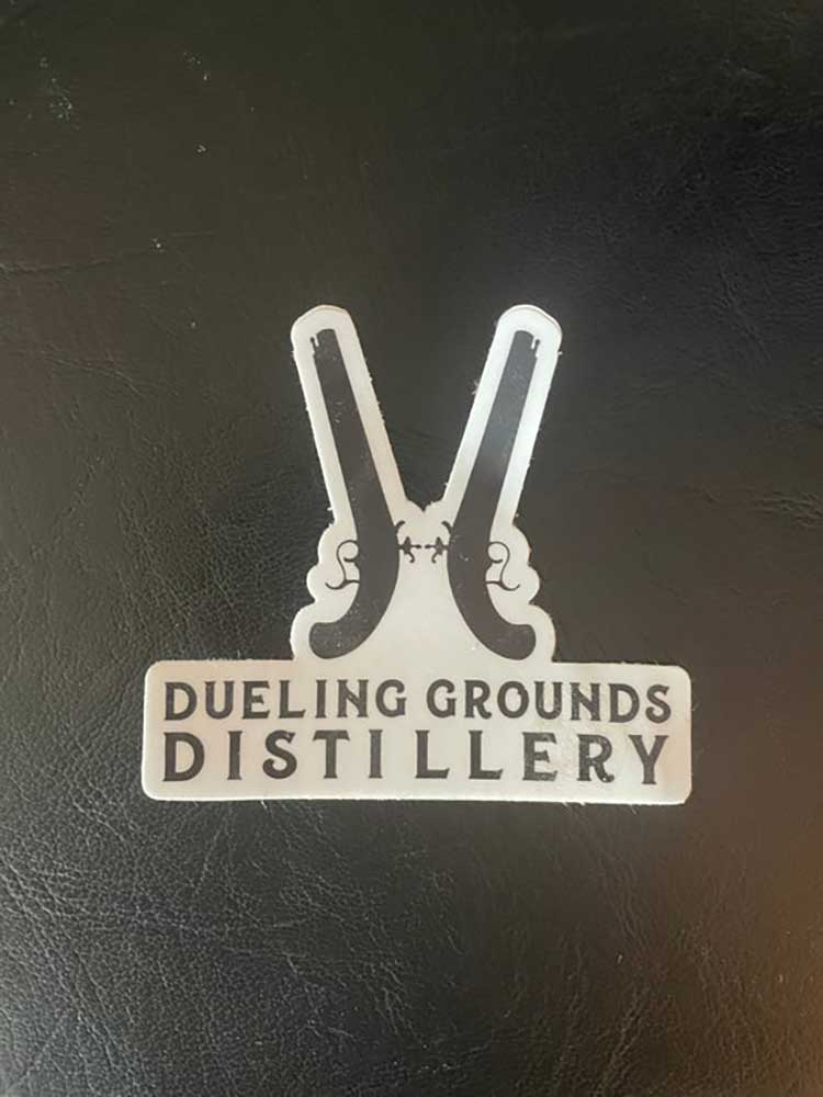 Dueling Grounds Double Guns Sticker